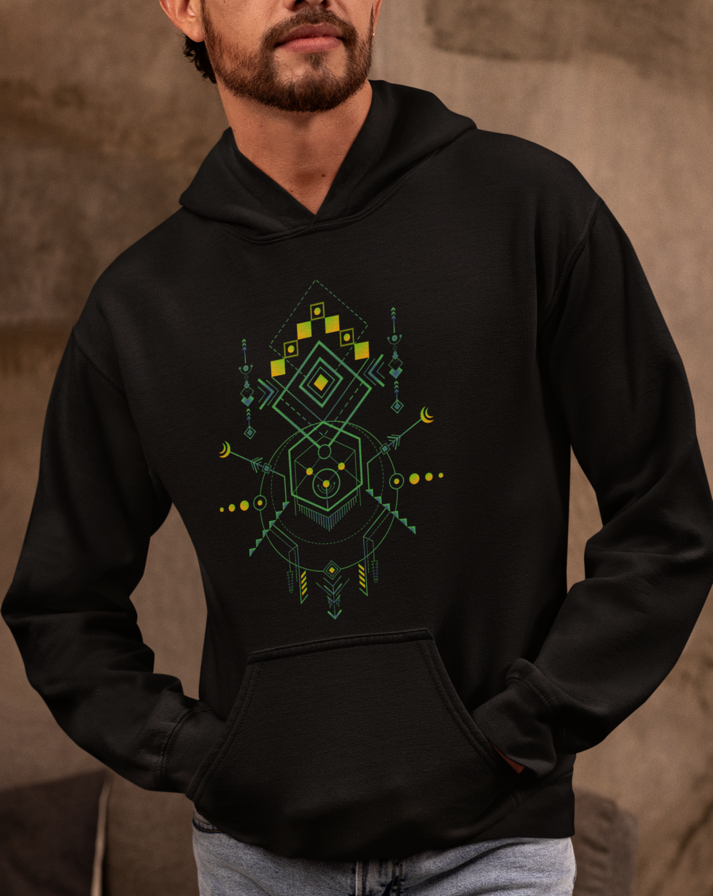 Person wearing a black hoodie with a geometric design on a neutral background